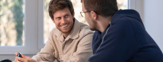 A pair of Tractive employees discussing work