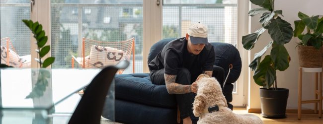 A man preparing to leave his dog home alone