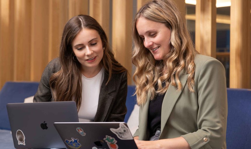 A pair of Tractive employees working together on a project